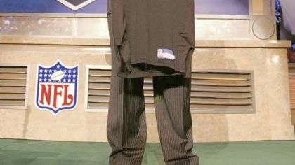 Ben Roethlisberger, then a 22-year-old quarterback from Miami of Ohio, holds up a Steelers' jersey after being selected 11th overall in the first round at the NFL draft Saturday, April 24, 2004 in New York.