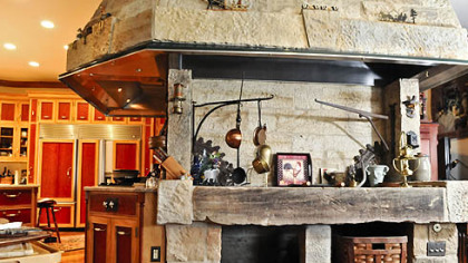 The wood-fired grill extends from the wrap-around wall from the kitchen and connects with one of the two dining areas.