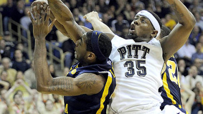Pitt forward Nasir Robinson gets tangled up with West Virginia forward John Flowers in the first half of Friday's game at the Petersen Events Center.