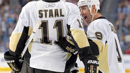Pascal Dupuis, right, celebrates his third-period goal with Jordan Staal.