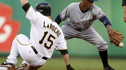 The Pirates' Andy LaRoche slides safely into second with a double as Brewers' shortstop Alcides Escobar takes the late throw from right field during the first inning.