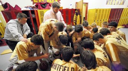 Chartiers-Houston coach Jerry Cypher, left, says The Lord's Prayer with the team in the locker room before taking on Monessen Tuesday.