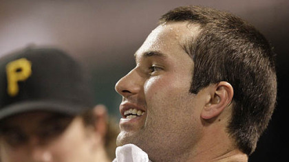 The Pirates' Neil Walker wipes his face in the dugout Tuesday at Great American Ball Park.