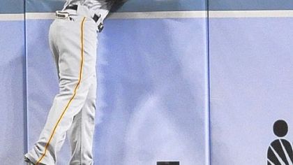 Pirates center fielder Andrew McCutchen is unable to catch a three-run home run by Dodgers' Andre Ethier in the third inning.