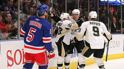 Penguins forawrd Chris Conner celebrates his first period goal at with teammates Sidney Crosby and Pascal Dupuis as Rangers defenseman Dan Girardi skates away.