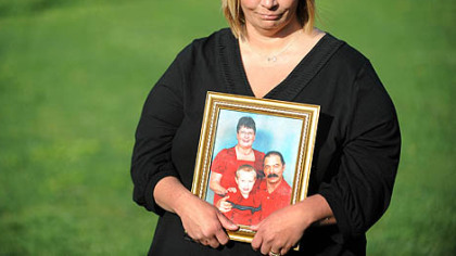 Michelle McKinney holds a photo of her father Benny Willingham, one of the miners killed in the West Virginia coal mine explosion. She spoke with the media at Marsh Fork Elementary School.