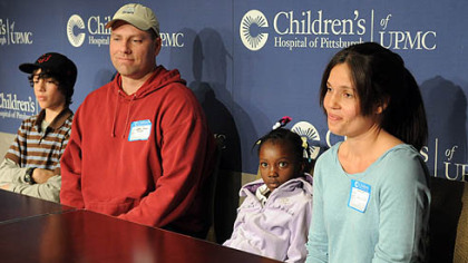 The Brock family (Austin, 12, Nathan and Catrina) with their new addition, Dania, 7, one of the orphans rescued from Haiti and brought to Pittsburgh on Tuesday.