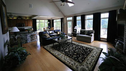 Two skylights and many tall windows add to the spacious feel of the 20-by-19-foot great room, which has a hardwood floor and floor-to-ceiling gas fireplace.