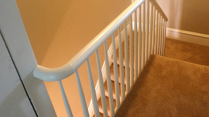The restored railing from the second leading down to the first floor.