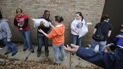 Thirty-eight Shaler Area High School students, supervised by Hosanna Industries, volunteered Friday to help Etna prepare for possible flooding by placing sandbags around the Etna Borough Building. They also helped residents move items from their basements.