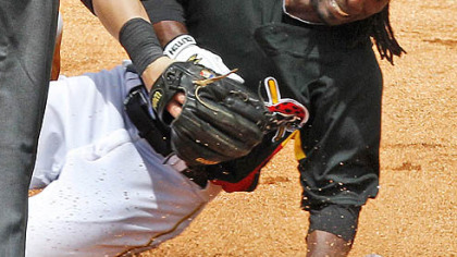 Pirates outfielder Andrew McCutchen slides into Astros third baseman Chris Johnson with a triple as he is hit by the throw from Astros center fielder Jason Michaels during the second inning.