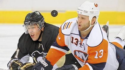 Penguins forward Evgeni Malkin is tripped up by Islanders forward Robbie Schremp.