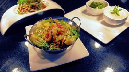 Among items on the menu at Habitat in the Fairmont Pittsburgh are lobster lo mein, front, tandoor chicken tacos, left, and marinated Elysian Fields lamb with tamarind and green chile glaze.