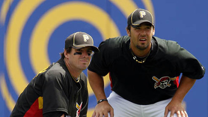 Pirates outfielder Garrett Jones, right, and third baseman Andy LaRoche warm up in the outfield.