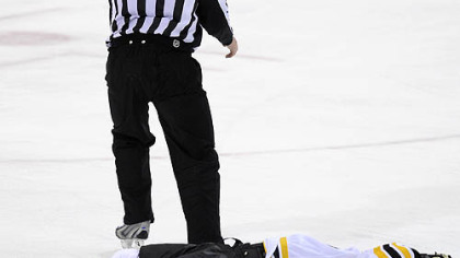 Bruins forward Marc Savard lays on the ice after taking a hit by Penguins forward Matt Cooke in the third period of Sunday's game.
