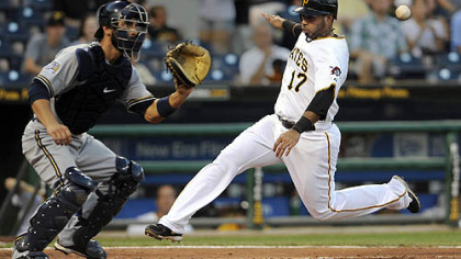 The Pirates' Pedro Alvarez scores against Brewers catcher George Kottaras in the fourth inning.