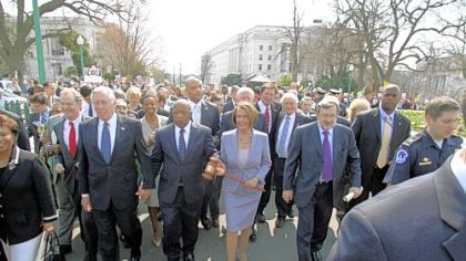 House Speaker Nancy Pelosi, D-Calif., carries the gavel used when Medicare passed in 1965 as she crosses Independence Avenue to the U.S. Capitol with other Democrats before the House voted on health care legislation on Sunday. At right is Rep. David Obey, D-Wisc., at left are Reps. Chris Van Hollen, D-Md., Steny Hoyer, D-Md. and John Lewis, D-Ga.