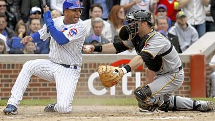 Pirates catcher Ryan Doumit tags out the Cubs' Aramis Ramirez to end the third inning Saturday at Wrigley Field, this after a strong throw from left fielder Ryan Church.