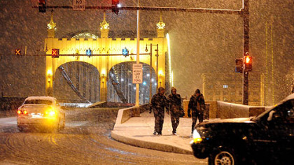 Snow falls on the Smithfield Street Bridge in downtown.