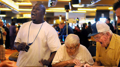 David Joyner, left, of Penn Hills, yells as Helen and George Hutman of Center, Beaver County, play craps at the Rivers Casino on the North Shore on Thursday.