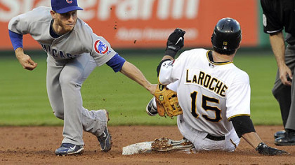 The Pirates' Andy LaRoche slides into second base safely as Cubs second baseman Mike Fontenot applies the tag in the third inning.