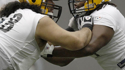 Steelers offensive guard Chris Kemoeatu, left, battles with fifth round draft choice, offensive tackle Chris Scott out of Tennessee, during training drills at the team's facility on the South Side June 9. Scott signed with the Steelers Wednesday.