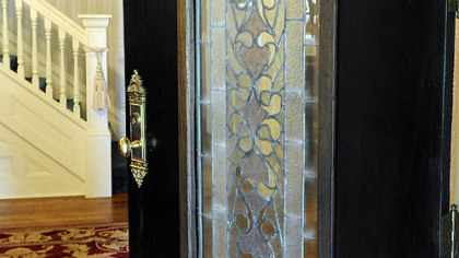 The leaded glass front door opens into the 12-by-12-foot foyer.