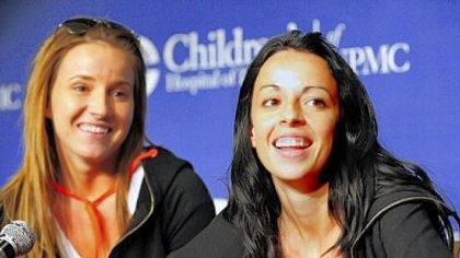 Ali McMutrie, 22, left, and her sister, Jamie McMutrie Heckman, 30, speak together at a news conference at Children's Hospital of Pittsburgh of UPMC.