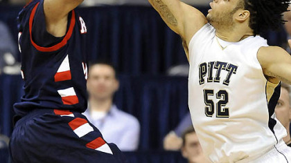 Pitt center Gary McGhee bocks a shot by Robert Morris forward Rob Robinson in the second half of last night's game at the Petersen Events Center.