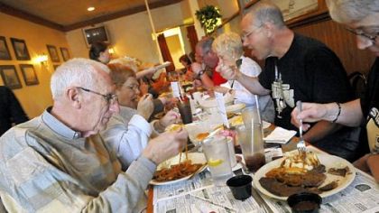 Jim Slopey, left, and his wife, Marcia, of Penn Hills, tuck into the featured dish at their first Liver and Onions Club meeting at Mohan's in Penn Hills.