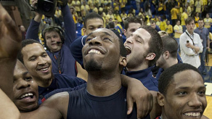 Robert Morris gaurd Mezie Nwigwe, center, celebrates with his teammates.