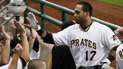 The Pirates' Pedro Alvarez returns to the dugout after hitting a grand slam off Brewers pitcher Dave Bush in the first inning.