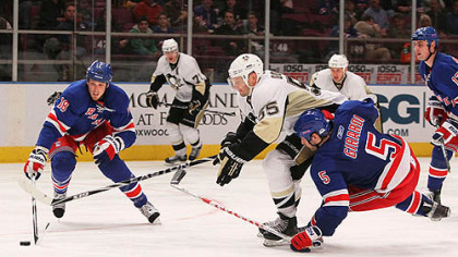 Penguins defenseman Sergei Gonchar battles for the puck against Rangers defensemen Dan Girardi and Marc Staal.