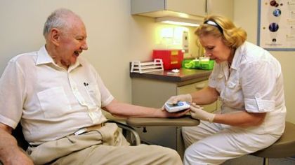 John Rose, 85, of Point Breeze, has his blood checked by medical assistant Margarita Bidrat at the Squirrel Hill Health Center. A long-time patient of geriatrician Andrea Fox, Mr. Rose was the first patient at the clinic when it opened 3 1/2 years ago.
