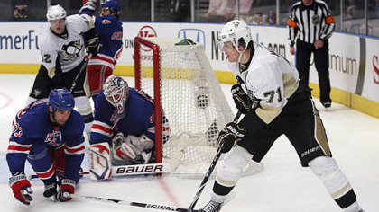Rangers defenseman Michal Rozsival and goaltender Henrik Lundqvist defend the net against Penguins forward Evgeni Malkin during the third period.