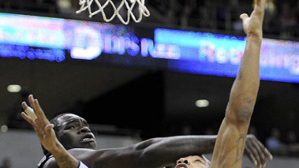 Pitt's Jermaine Dixon drives to the net against Providence's Jamine Peterson in the first half.