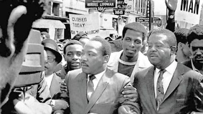 The Rev. Dr. Martin Luther King Jr. and the Rev. Ralph Abernathy, right, lead a march on behalf of striking Memphis sanitation workers on March 28, 1968.