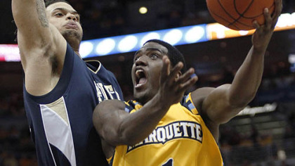 Marquette's Darius Johnson-Odom drives to the basket against Pitt's Gary McGhee during the first half.