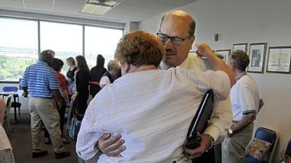 Leah Lipner, left, gives John Tarka, president of the Pittsburgh Federation of Teachers, a congratulatory hug Monday.