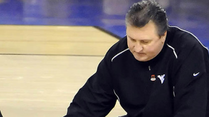 West Virginia coach Bob Huggins comforts Da'Sean Butler after Butler injured injuring his leg against Duke in the second half of the semifinal game in the NCAA tournament in Indianapolis last night.