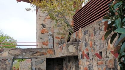 A small reflecting pool outside the Kiva, a vault-like room used for storage, entertainment and meetings.