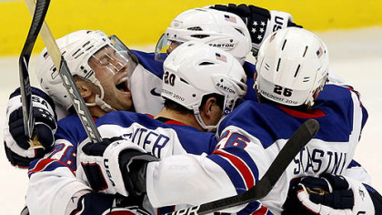 Brian Rafalski, left, celebrates with U.S. teammates Ryan Suter and Paul Stastny right after the final horn Sunday.