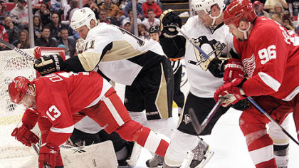 Red Wings forward Pavel Datsyuk, left and Tomas Holmstrom battle with Penguins forward Jordan Staal, left, and defenseman Alex Goligoski during the second period.