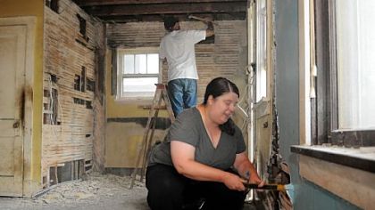 Kelly Carter and Ben Smith work in the kitchen of their latest home remodeling project on Francisco Street in Sheraden.  The couple have renovated five homes in eight years in their neighborhood and now rent the properties.