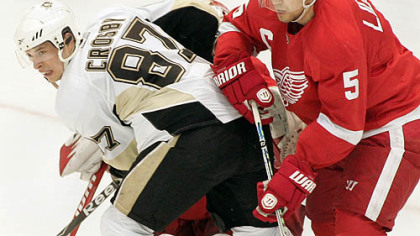 Red Wings captain Nicklas Lidstrom pushes Penguins captain Sidney Crosby away from the goal during the third period of Detroit's 3-1 home win at Joe Louis Arena, Monday.