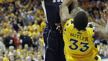 Pitt Travon Woodall is charged with an offensive foul against Marquette's Jimmy Butler in the second half of last night's game in Milwaukee.
