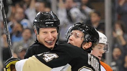 Jordan Staal celebrates with Matt Cooke after Cooke scores in the first period.
