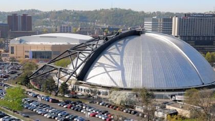 Mellon Arena looms in the foreground as the new Consol Energy Center rises behind it.