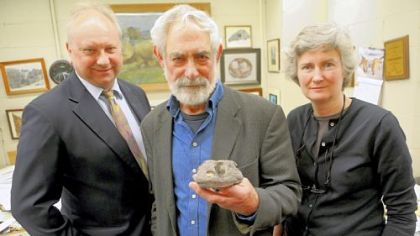 Carnegie Museum of Natural History's Curator of Vertebrate Paleontology David S. Berman holds the fossil of a trematopid temnospondyl amphibian -- a new genus of carnivorous amphibian -- found on FedEx property at the Pittsburgh International Airport. He stands with Albert D. Kollar, Collection Manager of Invertebrate Paleontology, and Amy C. Henrici, Collection Manager of Vertebrate Paleontology.