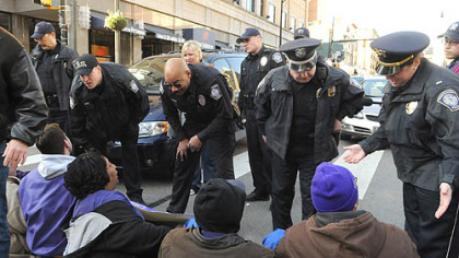 University of Pittsburgh police officers talk with supporters of Sodexo food service workers, who held at "sit in" in the middle of Forbes Avenue in Oakland.